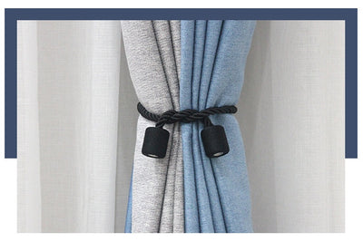 Black cylindrical magnetic curtain tieback holding a light blue pleated curtain, against a clean white background. - Image 17