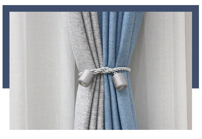 Black cylindrical magnetic curtain tieback holding a light blue pleated curtain, against a clean white background. - Image 18
