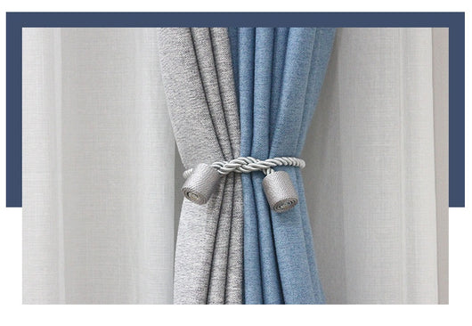 Black cylindrical magnetic curtain tieback holding a light blue pleated curtain, against a clean white background. - Image 18