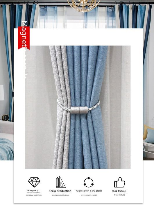 Black cylindrical magnetic curtain tieback holding a light blue pleated curtain, against a clean white background. - Image 19