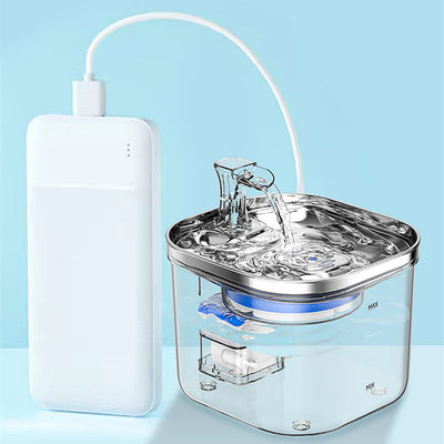 Automatic pet water fountain with clear reservoir, stainless steel top, and flowing water spout, shown with power adapter and filter set. - Image 16