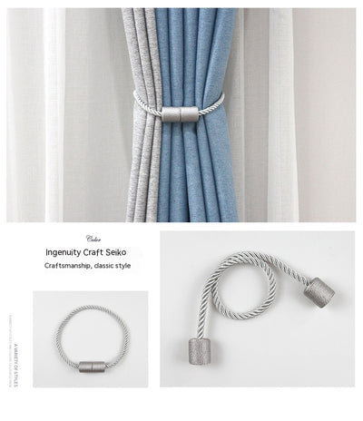 Black cylindrical magnetic curtain tieback holding a light blue pleated curtain, against a clean white background. - Image 25