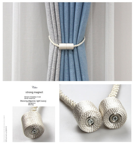 Black cylindrical magnetic curtain tieback holding a light blue pleated curtain, against a clean white background. - Image 31