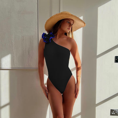 Black one-shoulder ribbed one-piece swimsuit with a ruffled blue and black strap, ideal for women's swimwear. - Image 51