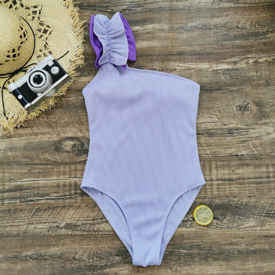 Black one-shoulder ribbed one-piece swimsuit with a ruffled blue and black strap, ideal for women's swimwear. - Image 52