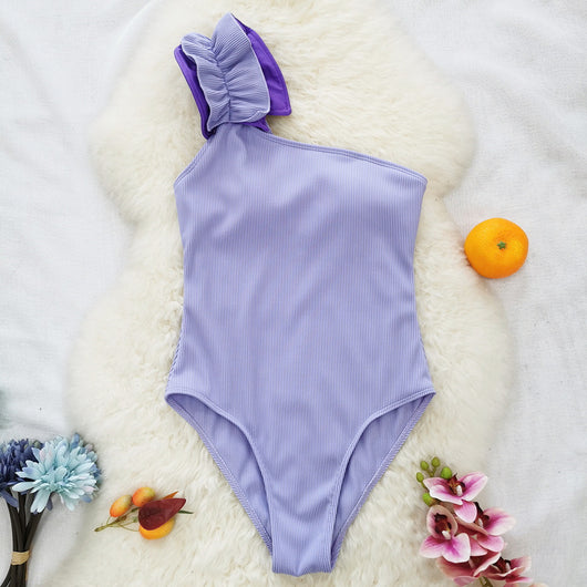 Black one-shoulder ribbed one-piece swimsuit with a ruffled blue and black strap, ideal for women's swimwear. - Image 55