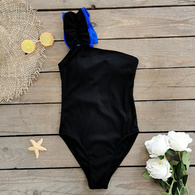 Black one-shoulder ribbed one-piece swimsuit with a ruffled blue and black strap, ideal for women's swimwear. - Image 68