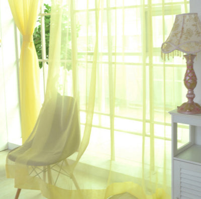Close-up of a solid red sheer tulle curtain hanging in front of a window, allowing light to filter through. - Image 26