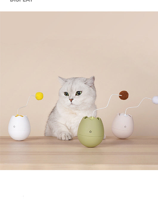 White egg-shaped automatic cat toy with a yellow interior and a flexible wire holding a yellow fuzzy ball. - Image 12