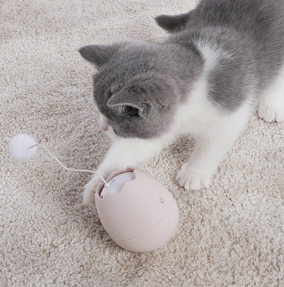 White egg-shaped automatic cat toy with a yellow interior and a flexible wire holding a yellow fuzzy ball. - Image 14