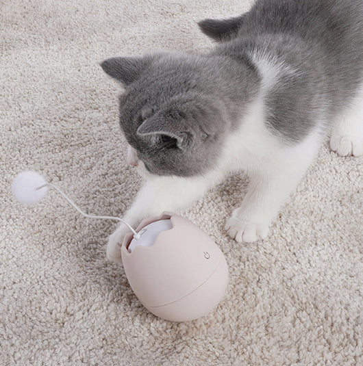 White egg-shaped automatic cat toy with a yellow interior and a flexible wire holding a yellow fuzzy ball. - Image 14