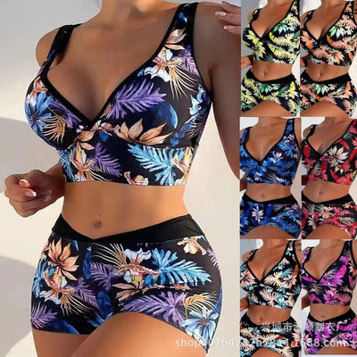 Two-piece swimsuit with a black background and vibrant pink and purple tropical floral print. Features a V-neck crop top and high-waisted boxer shorts. - Image 24