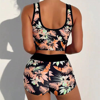 Two-piece swimsuit with a black background and vibrant pink and purple tropical floral print. Features a V-neck crop top and high-waisted boxer shorts. - Image 33