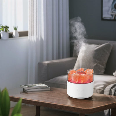 White cool-mist humidifier and aroma diffuser with glowing blue LED lights and orange crystal salt rocks, emitting mist. - Image 17