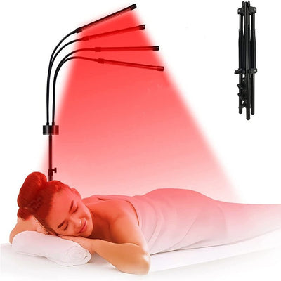 Red light therapy lamp with four adjustable arms illuminating a person lying on a white massage table. - Image 17