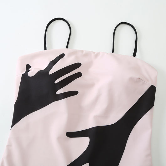 Women's light pink one-piece bikini with black handprint pattern and matching tie-waist sarong. - Image 21
