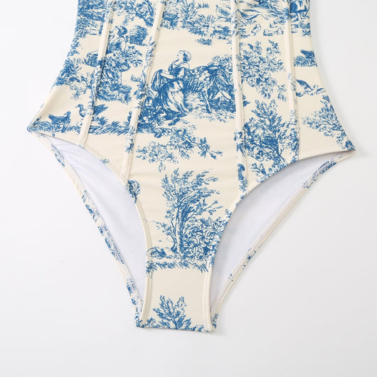 White sarong with blue toile de Jouy pattern featuring nature scenes, tied at the waist with a solid blue sash. - Image 14