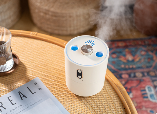 White volcanic flame aroma essential oil diffuser emitting orange light and mist on a wooden desk next to a laptop. - Image 15
