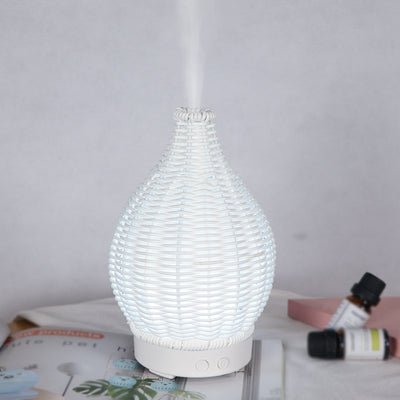 Mini ultrasonic aroma diffuser with a brown hollow rattan-style body and a white base, featuring control buttons. - Image 11