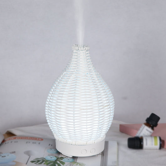 Mini ultrasonic aroma diffuser with a brown hollow rattan-style body and a white base, featuring control buttons. - Image 11