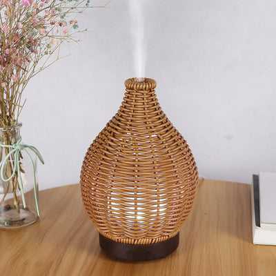Mini ultrasonic aroma diffuser with a brown hollow rattan-style body and a white base, featuring control buttons. - Image 12