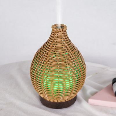 Mini ultrasonic aroma diffuser with a brown hollow rattan-style body and a white base, featuring control buttons. - Image 13