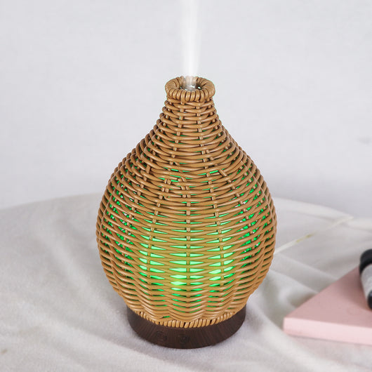 Mini ultrasonic aroma diffuser with a brown hollow rattan-style body and a white base, featuring control buttons. - Image 13