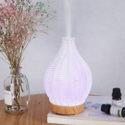 Mini ultrasonic aroma diffuser with a brown hollow rattan-style body and a white base, featuring control buttons. - Image 16