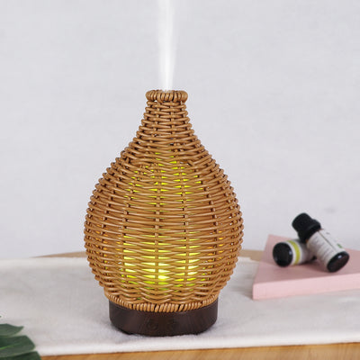 Mini ultrasonic aroma diffuser with a brown hollow rattan-style body and a white base, featuring control buttons. - Image 17