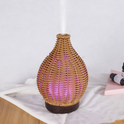 Mini ultrasonic aroma diffuser with a brown hollow rattan-style body and a white base, featuring control buttons. - Image 19