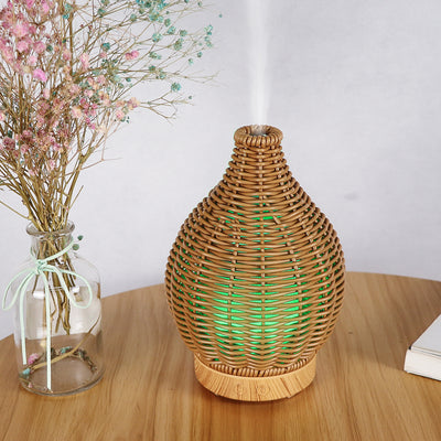 Mini ultrasonic aroma diffuser with a brown hollow rattan-style body and a white base, featuring control buttons. - Image 20