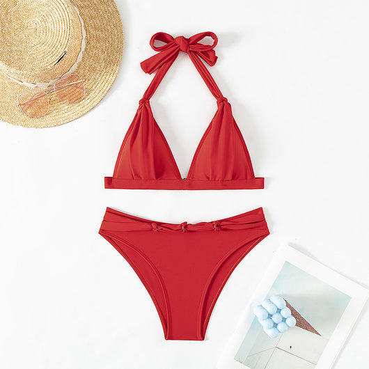 Red lace-up halterneck bikini modeled by a woman against a blue ocean and distant coastline. - Image 8