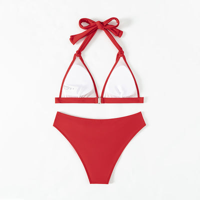 Red lace-up halterneck bikini modeled by a woman against a blue ocean and distant coastline. - Image 10