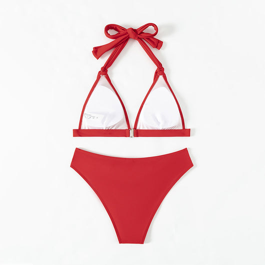 Red lace-up halterneck bikini modeled by a woman against a blue ocean and distant coastline. - Image 10