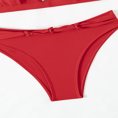 Red lace-up halterneck bikini modeled by a woman against a blue ocean and distant coastline. - Image 13