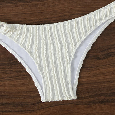 Women's white ribbed V-neck bikini with a front tie top and side ring bottoms, modeled by the ocean. - Image 7
