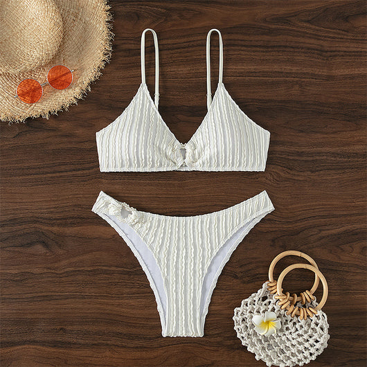 Women's white ribbed V-neck bikini with a front tie top and side ring bottoms, modeled by the ocean. - Image 11