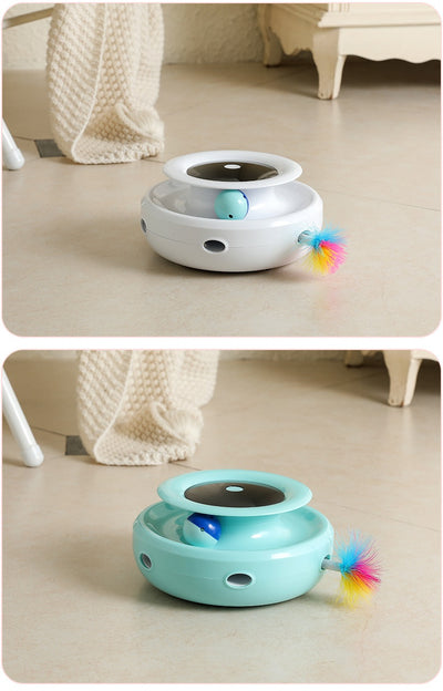 Grey and white cat observing a blue electric cat toy with a feather attachment and glowing blue lights. - Image 11