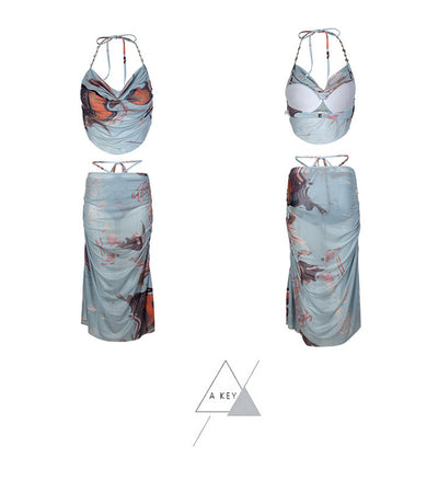 Light blue abstract print two-piece bikini set with a cropped halter top featuring chain straps and a ruched maxi skirt. - Image 10