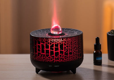 Black cylindrical aromatherapy diffuser with a crackle pattern, clear spherical top, and control buttons for timer and light. - Image 8