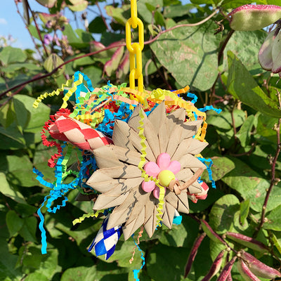 Colorful parrot chew toy made from natural fibers, featuring a woven ball, leaf-like accents, a bell, and a carabiner clip. - Image 18