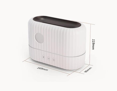 Dark gray simulated flame aromatherapy machine with a remote control, emitting a warm, flame-like light and mist. - Image 17