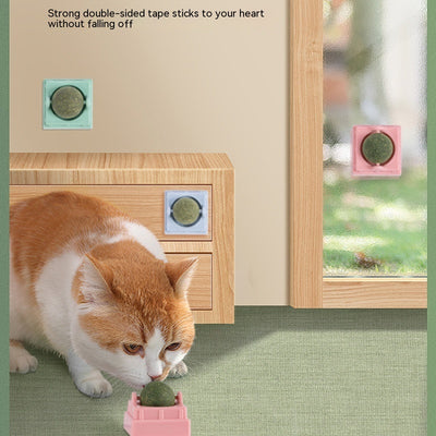 Two spinning catnip balls, one with a green base and one with a blue base, in clear plastic cases. - Image 9