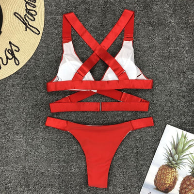 Woman in a white two-piece bikini with a halter-neck top and gold-toned hardware, holding a book and a red phone. - Image 38