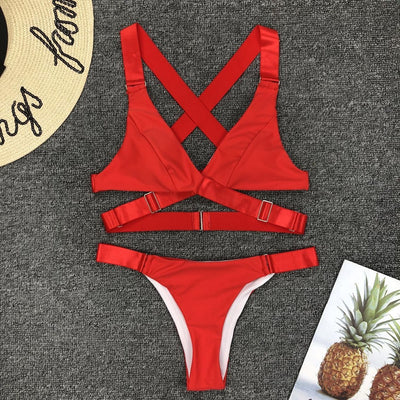 Woman in a white two-piece bikini with a halter-neck top and gold-toned hardware, holding a book and a red phone. - Image 39