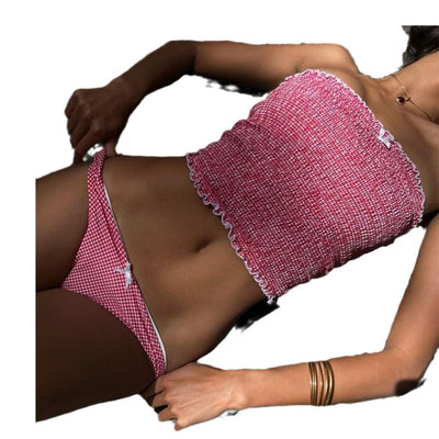 Woman in a red and white gingham smocked bandeau bikini top and high-cut bottoms with a small bow detail. - Image 13