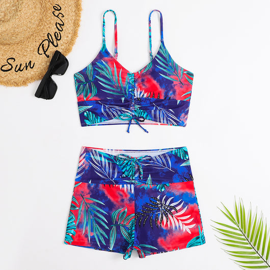 Women's two-piece swimsuit with tropical leaf and floral print. Features a ruched cropped camisole top and high-waisted swim shorts. - Image 10