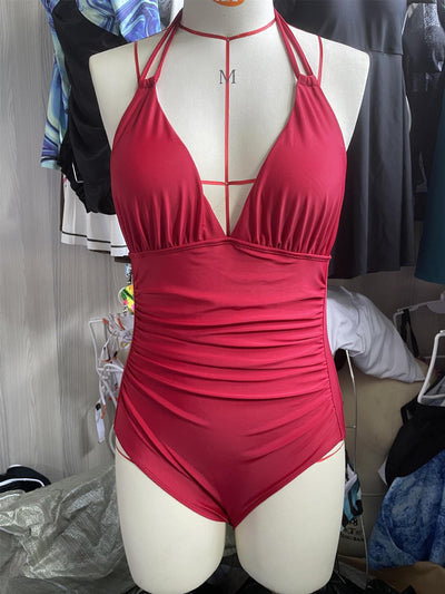 Teal halter one-piece swimsuit with a deep V-neck and ruched detailing on the bodice and sides. - Image 38