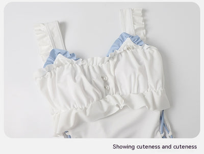 Women's white one-piece swimsuit with light blue lace-up sides, ruffled straps, and pearl-like buttons. - Image 14