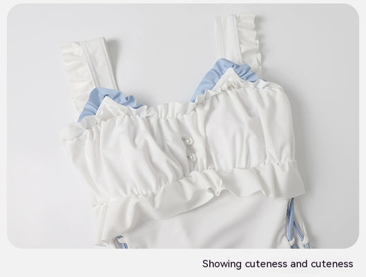 Women's white one-piece swimsuit with light blue lace-up sides, ruffled straps, and pearl-like buttons. - Image 14